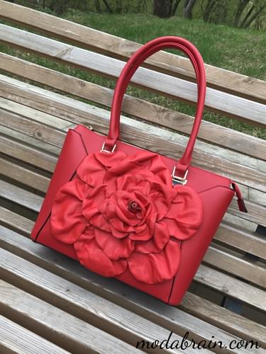 Decorating a bag with a big red rose